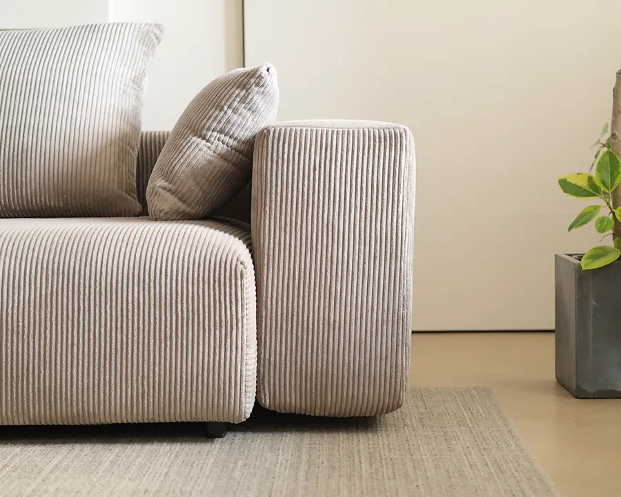 Rounded arm and base of the Marlow corduroy sofa